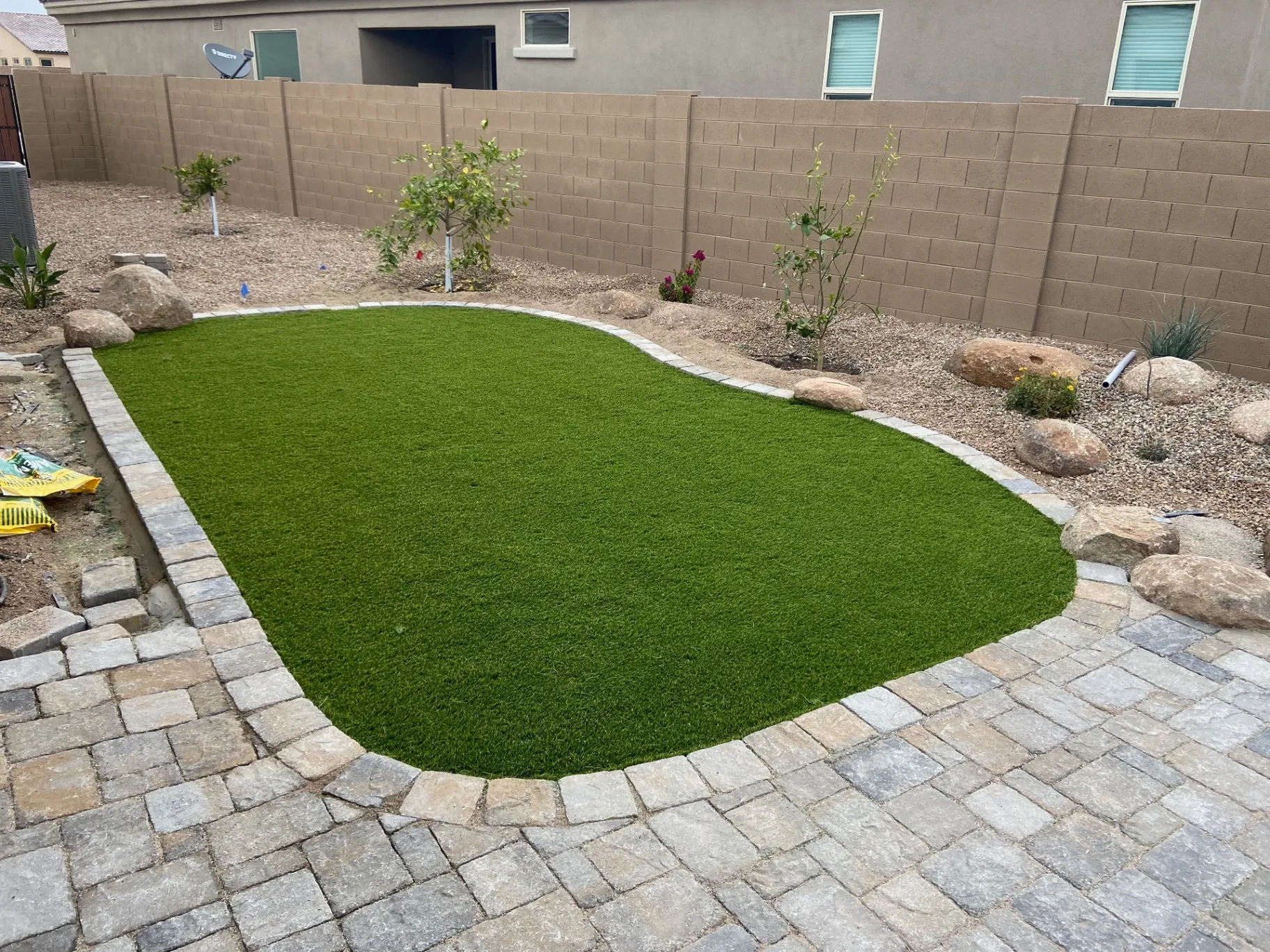 Synthetic turf lawn with paver border
