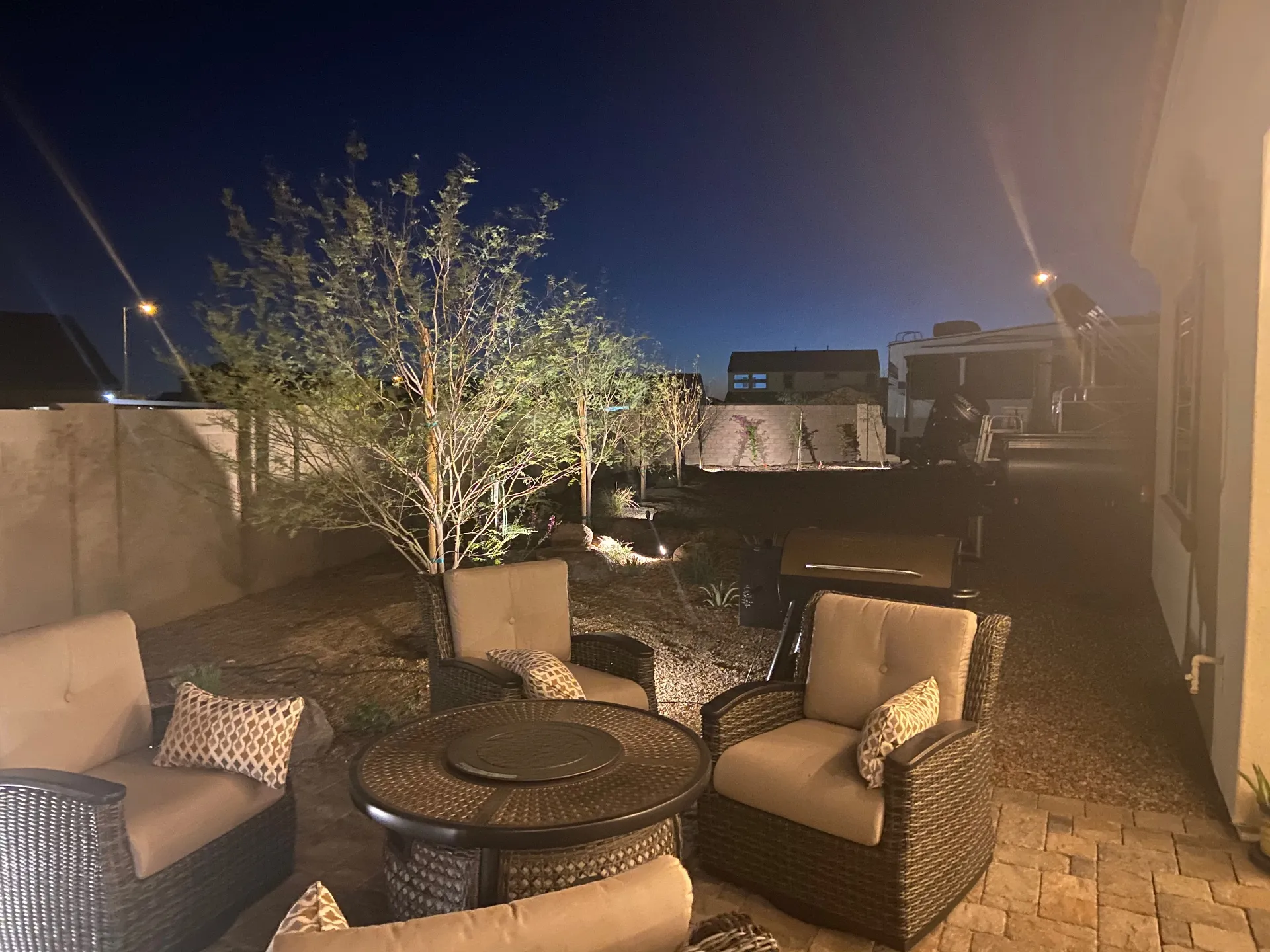 Backyard at night with landscape lighting