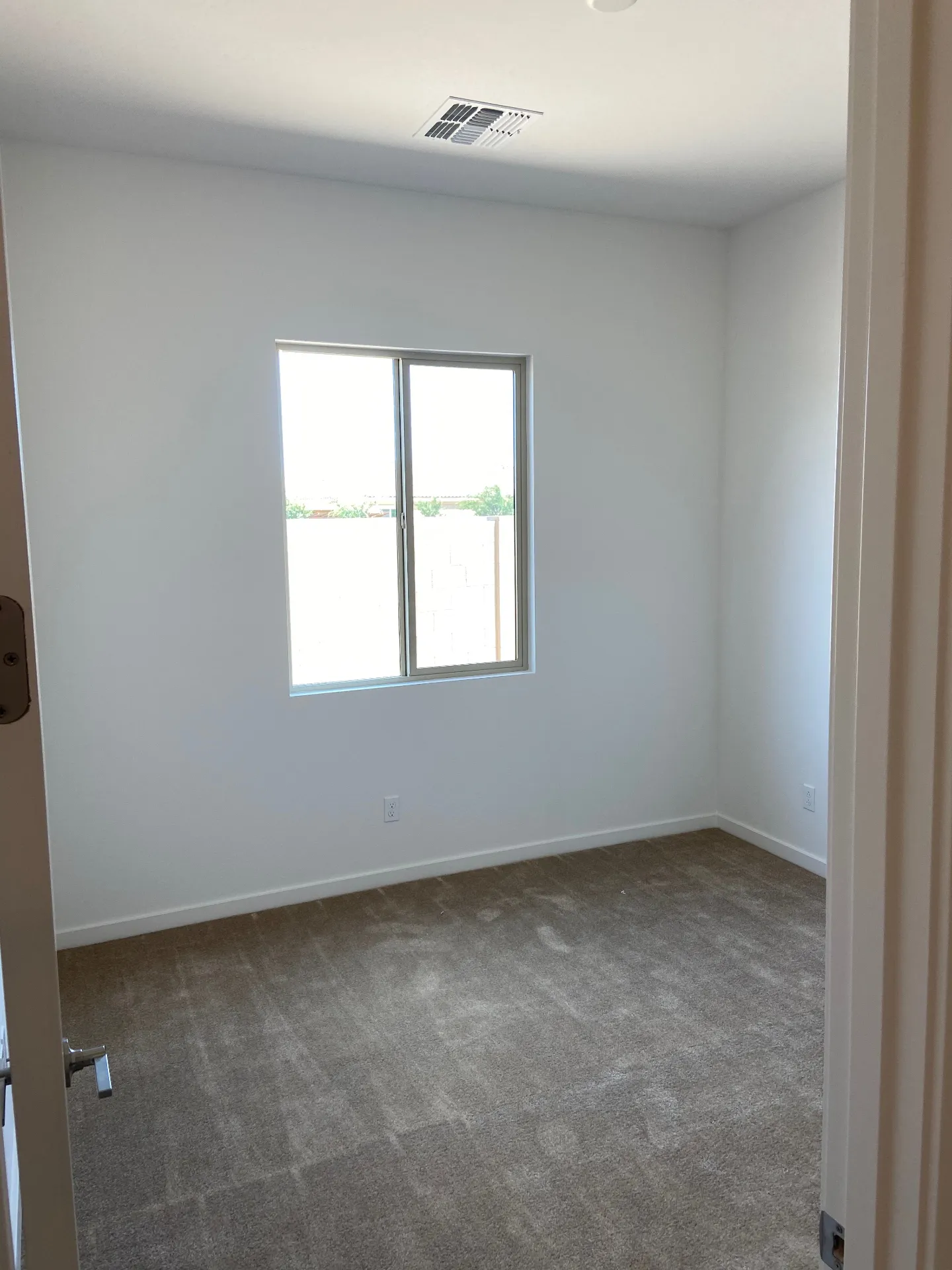 Kids room before renovation - plain carpet and bare walls